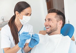 Dentist discussing Invisalign with a male patient