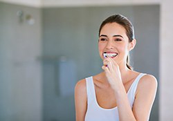 Young woman brushing her teeth