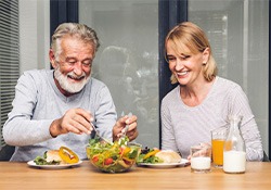 A smiling senior couple eating healthy foods