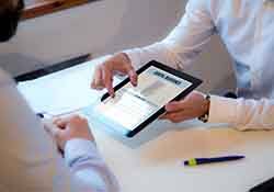 Dentist reviewing dental insurance form with patient