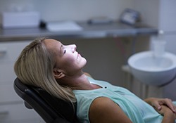 Relaxed woman sitting back in dental chair