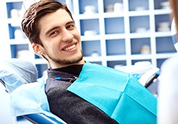 Male patient sitting in chair and smiling