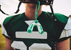 Mouthguard hanging from football players helmet